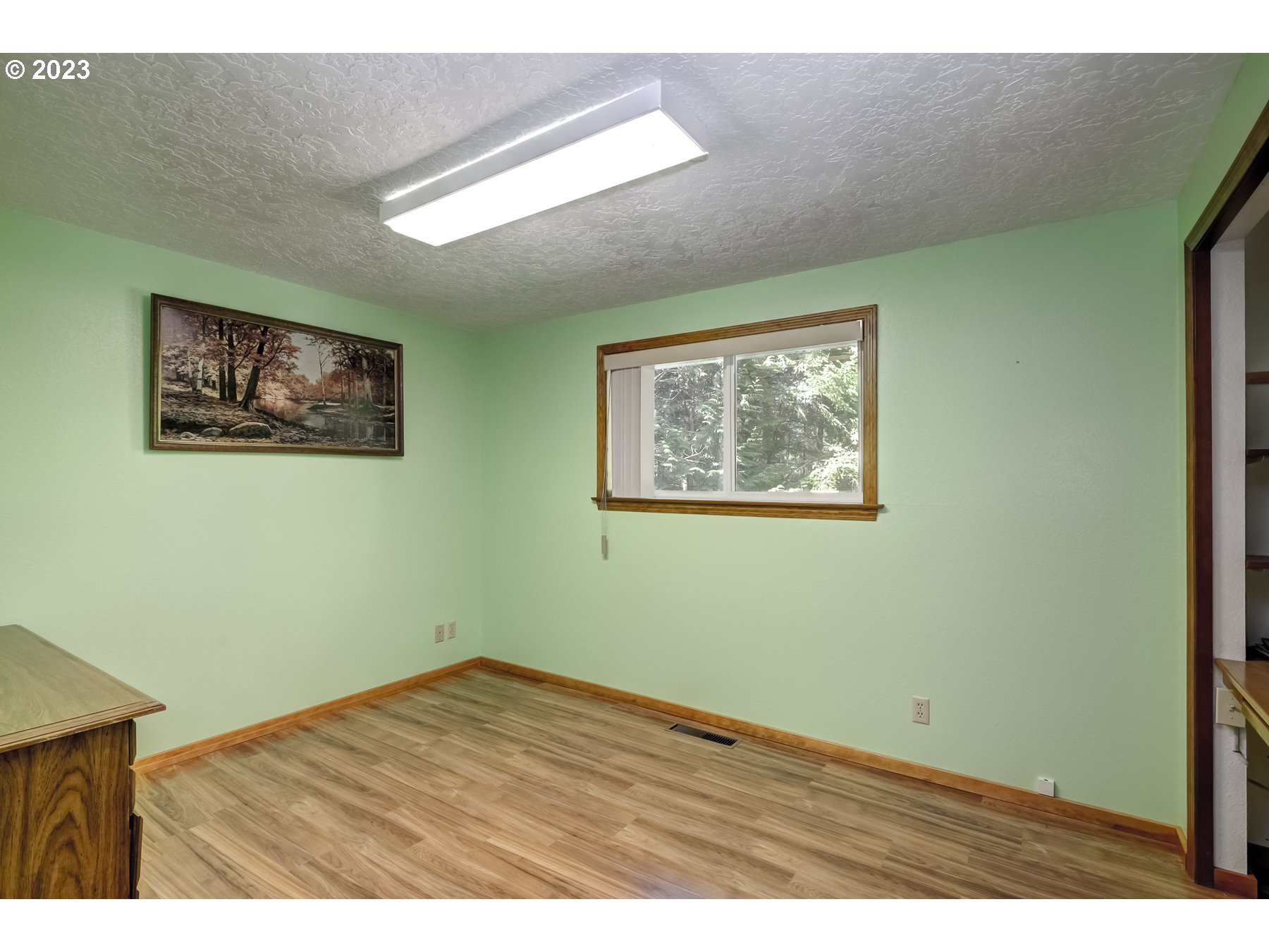 13100 Northwest Willis Road McMinnville, OR 97128 - Photo 22 of 38 a view of an empty room with wooden floor and painting on the wall