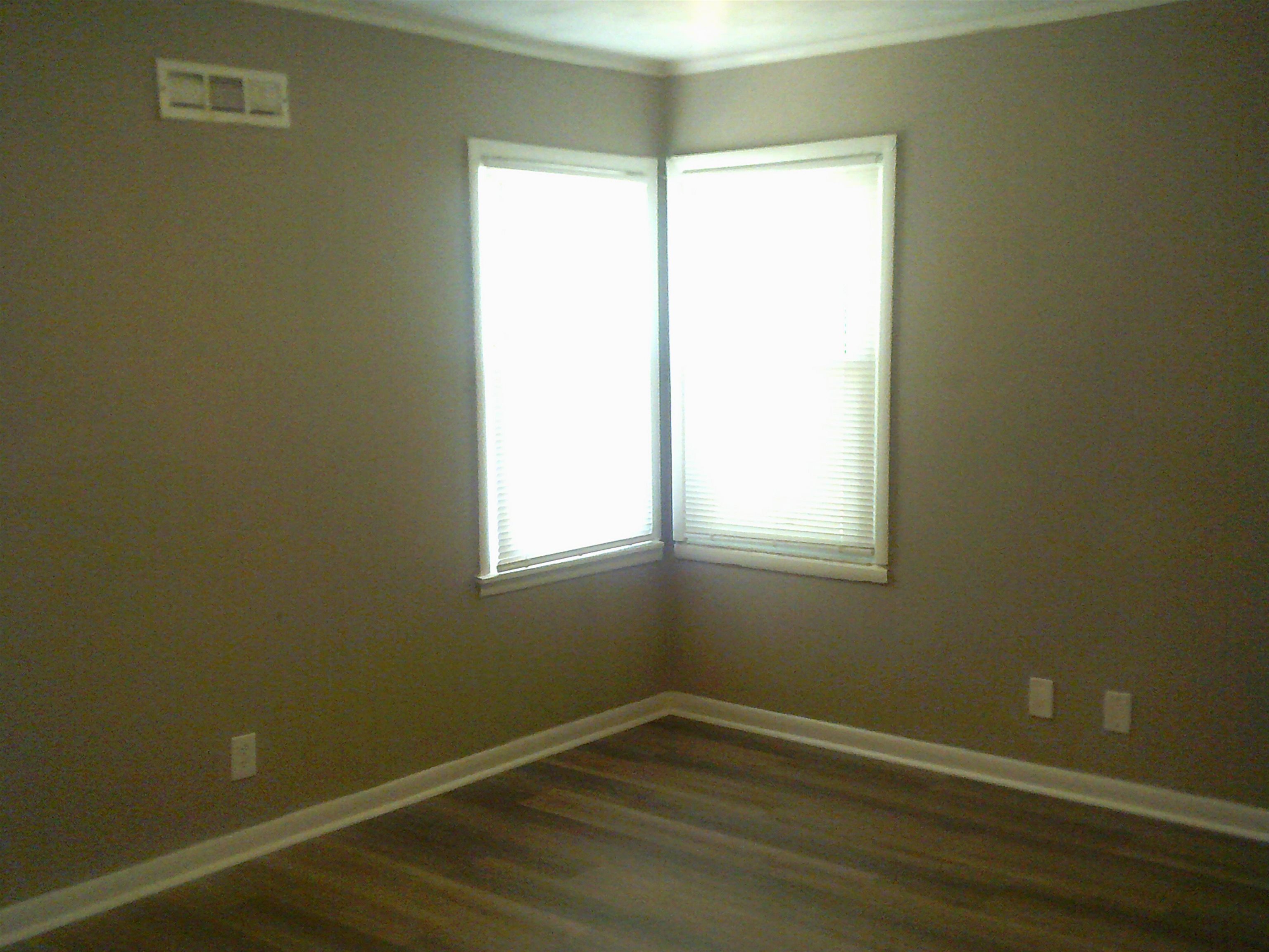 253 East Raines Road Memphis, TN 38109 - Photo 12 of 14 Empty room with dark wood-style floors and ornamental molding