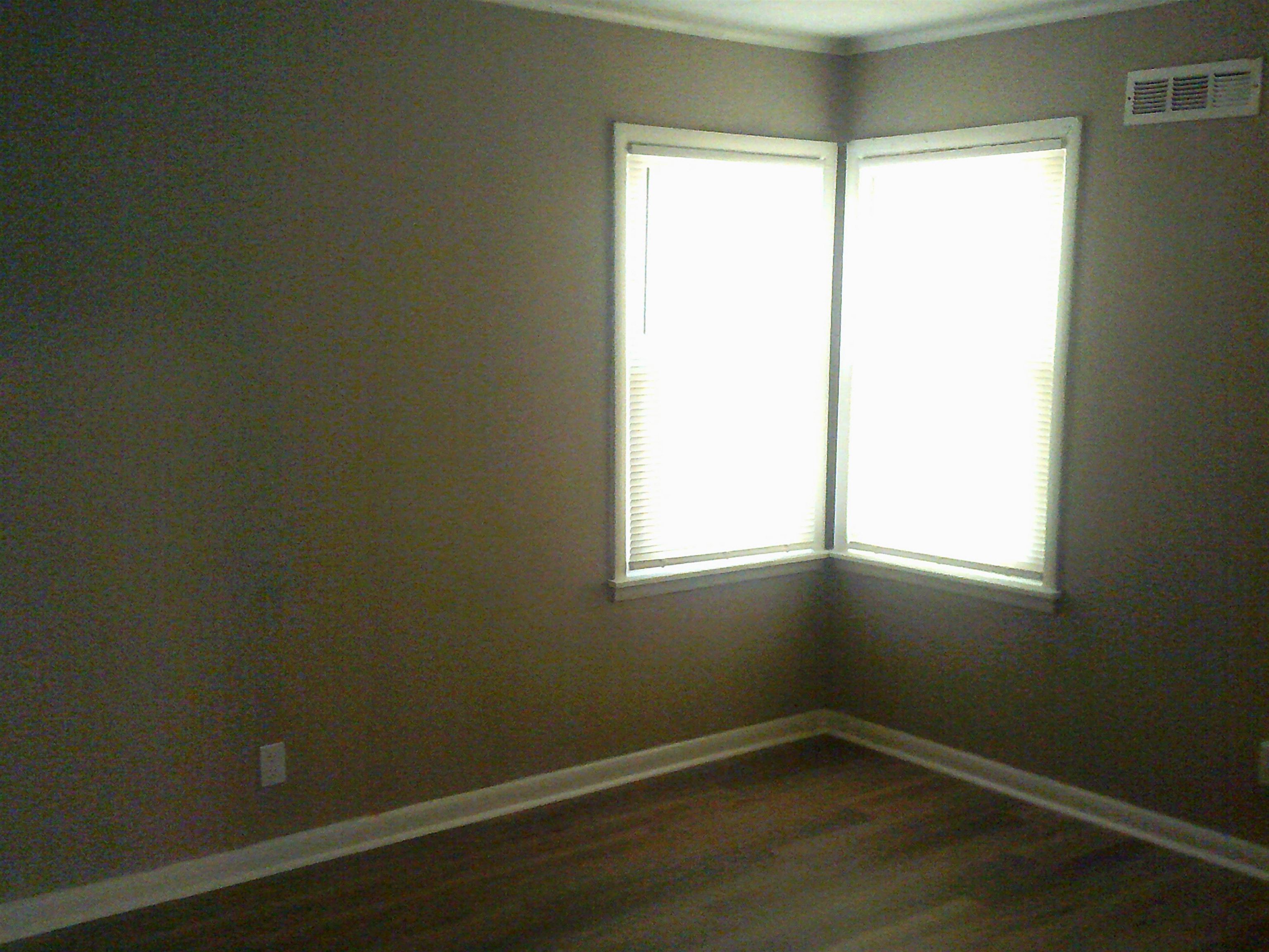 253 East Raines Road Memphis, TN 38109 - Photo 14 of 14 Empty room featuring dark wood finished floors and ornamental molding