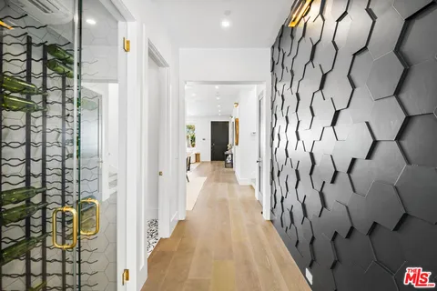 a kitchen with a dining table chairs sink and cabinets