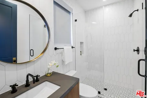 a bath tub sitting next to a white toilet