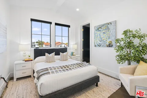 a bedroom with a bed and a lamp