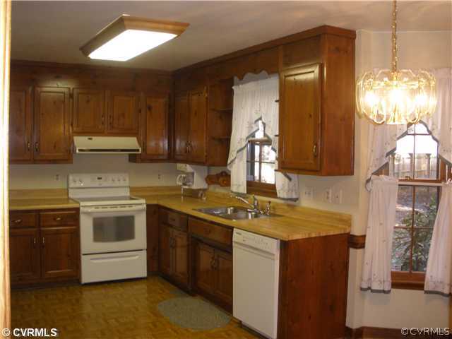 10751 Timberun Road Chesterfield, VA 23832 - Photo 3 of 10 a kitchen with stainless steel appliances granite countertop a sink stove and refrigerator