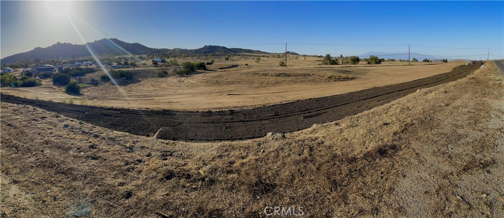 2 Juniper Flats Road Homeland, CA 92548 - Photo 1 of 1 a view of a dry yard with mountains in the background