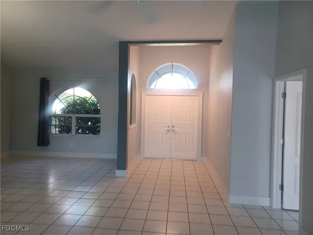 a view of a livingroom with a chandelier fan and window