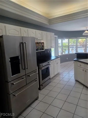 a kitchen with stainless steel appliances a stove a microwave and a refrigerator