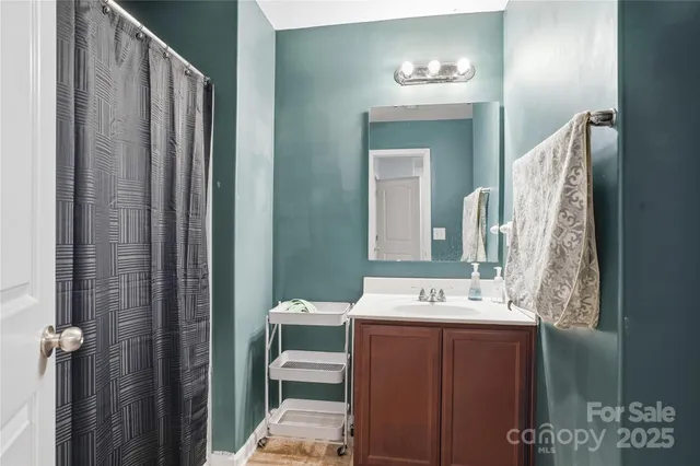 a bathroom with a sink vanity and a mirror