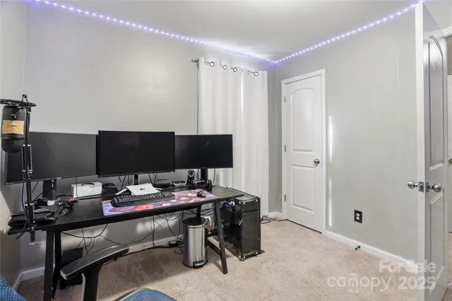 a view of a house with backyard and trees