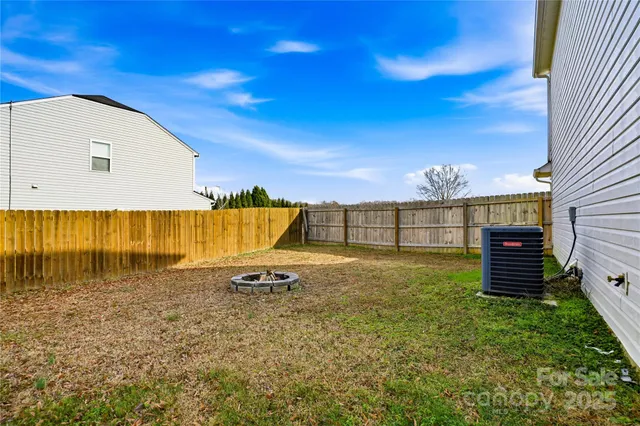 a view of a white house with a yard