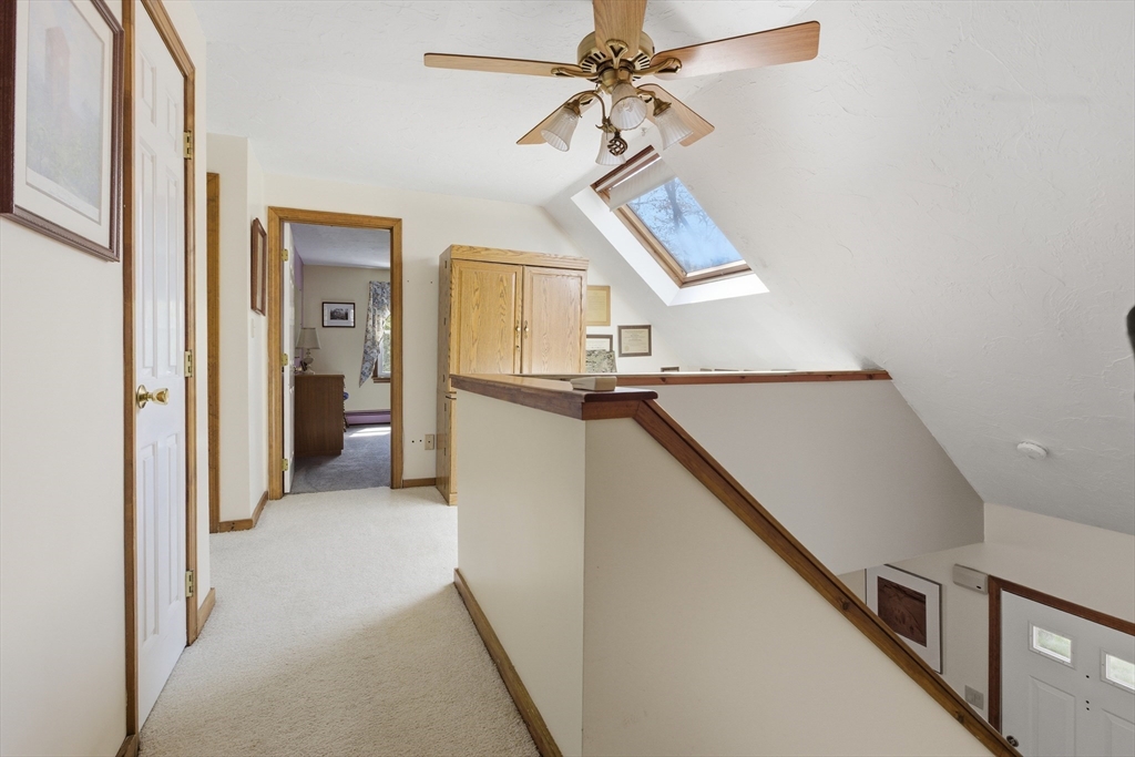 19 Mockingbird Lane Maynard, MA 01754 - Photo 13 of 34 a view of a hallway with a chandelier