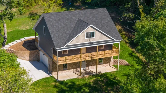 a front view of a house with a yard table and chairs