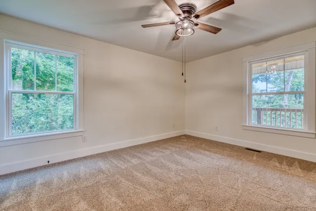a bathroom with a granite countertop toilet sink and mirror