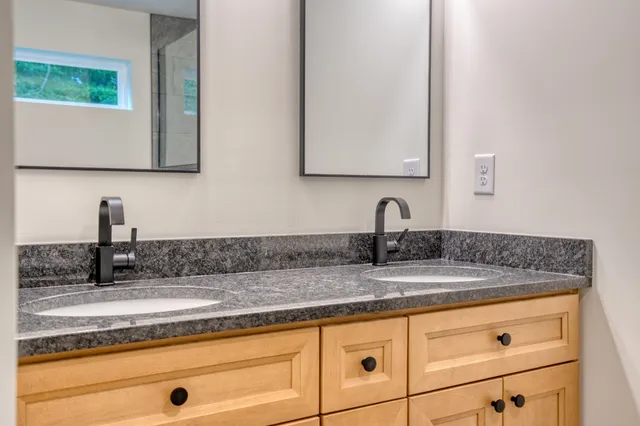 a kitchen with kitchen island a counter top space a sink appliances and a window