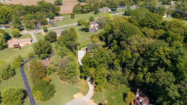 a view of a house with backyard and garden