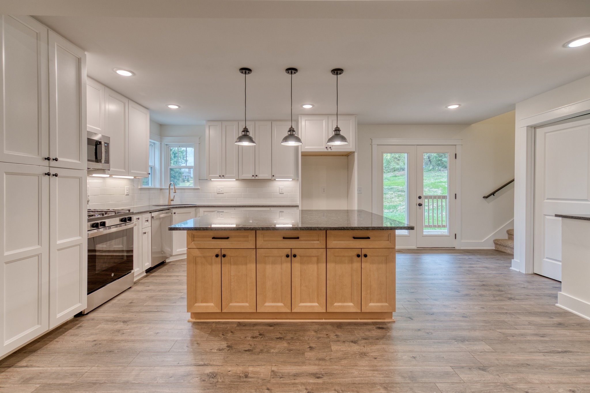 793 Spring Circle Springfield, TN 37172 - Photo 44 of 83 a large kitchen with stainless steel appliances granite countertop a stove a sink a refrigerator and a wooden cabinets