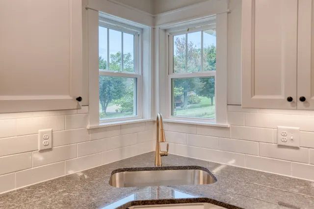 a house that has a big yard with large trees