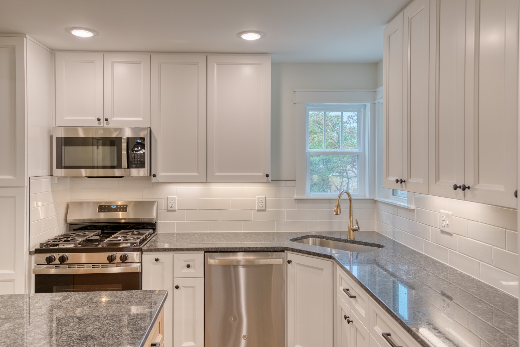 793 Spring Circle Springfield, TN 37172 - Photo 47 of 83 a kitchen with stainless steel appliances granite countertop a sink a stove a microwave and cabinets