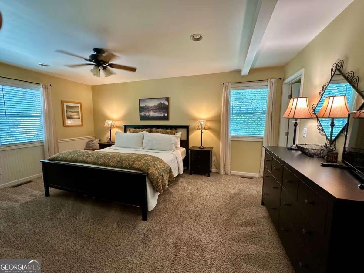 35 High Point Trail Blue Ridge, GA 30513 - Photo 11 of 18 a spacious bedroom with a bed and a flat tv screen on dresser