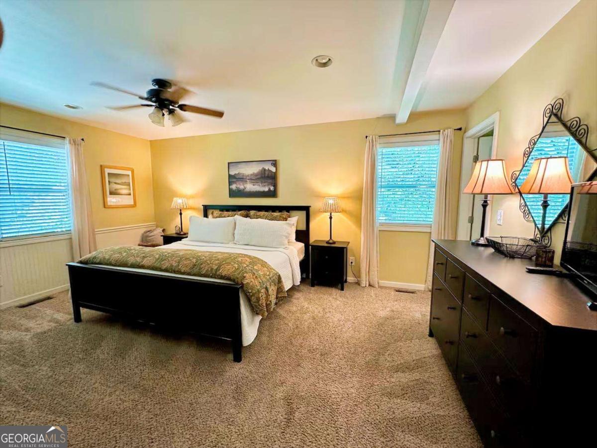 35 High Point Trail Blue Ridge, GA 30513 - Photo 12 of 18 a spacious bedroom with a bed and a flat tv screen on dresser