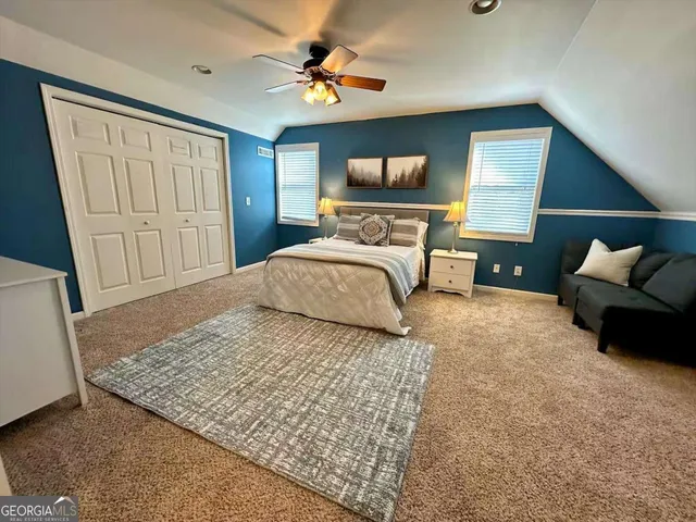 a bedroom with a bed and a couch