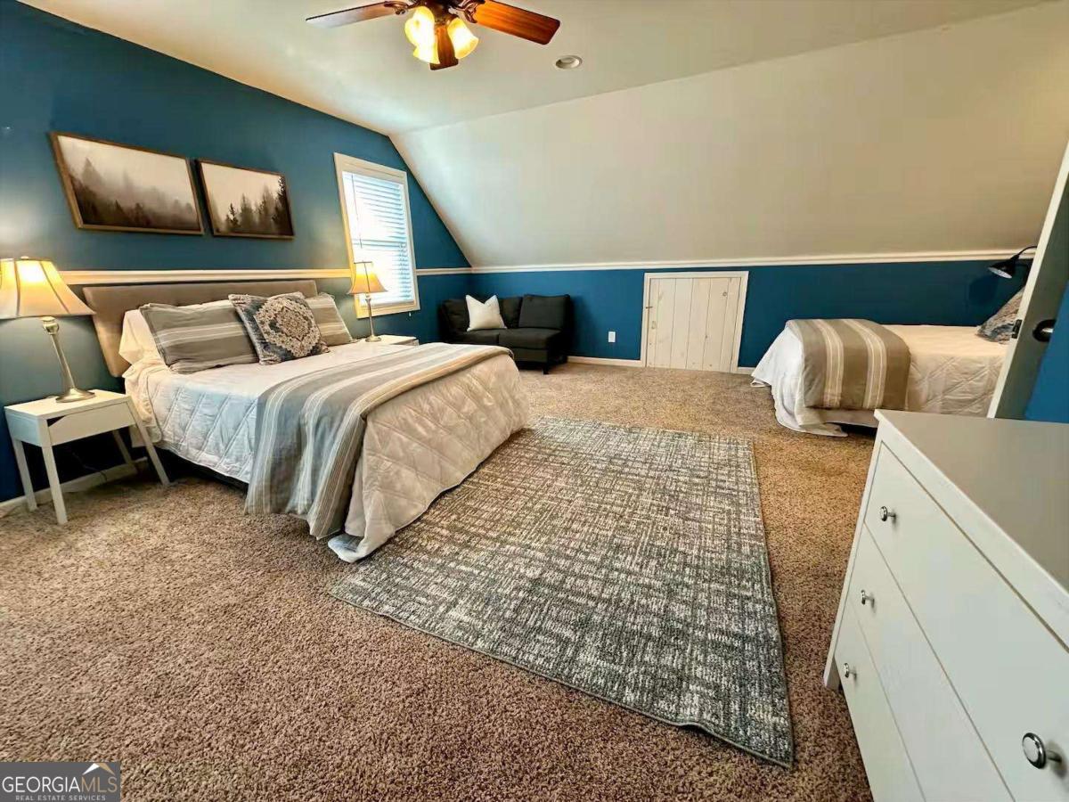 35 High Point Trail Blue Ridge, GA 30513 - Photo 16 of 18 a bedroom with bed and a chandelier