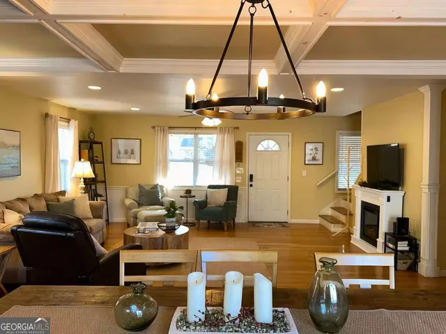 a living room with fireplace furniture and a flat screen tv