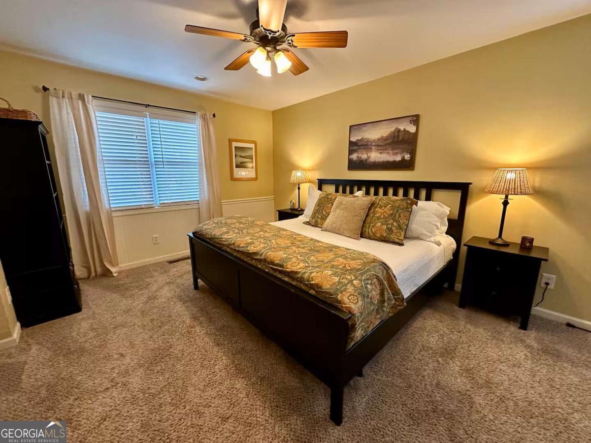 35 High Point Trail Blue Ridge, GA 30513 - Photo 8 of 18 a large bed sitting in a bedroom next to a window