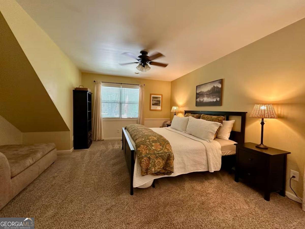 35 High Point Trail Blue Ridge, GA 30513 - Photo 10 of 18 a bedroom with bed and a chandelier