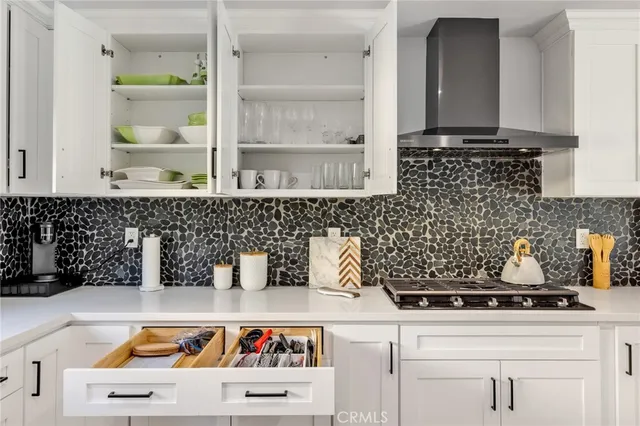 a kitchen with a sink a stove and cabinets