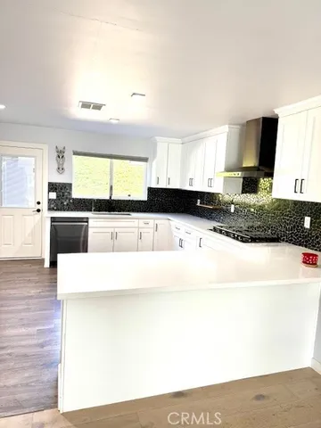 a kitchen with stainless steel appliances granite countertop a sink and a stove