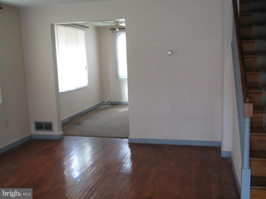 1936 Penhall Road Baltimore, MD 21222 - Photo 2 of 14 a view of a room with wooden floor and window