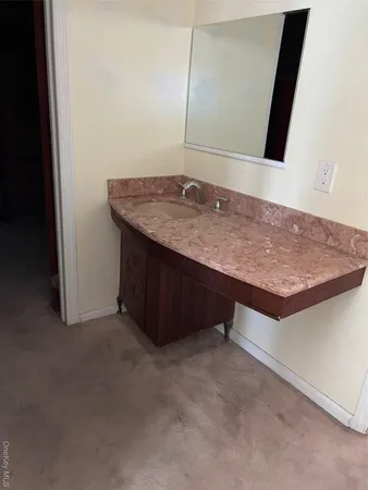 a room with a sink and a mirror