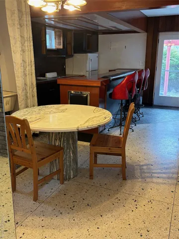 a dining room with a table and chairs