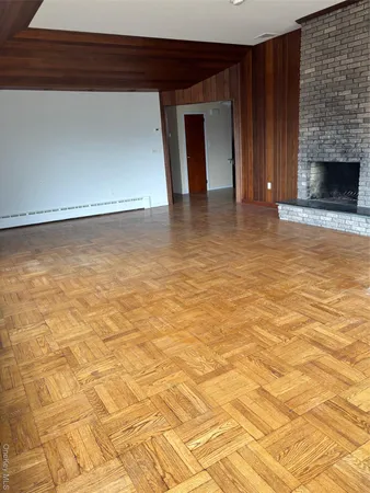 a view of empty room with a fireplace