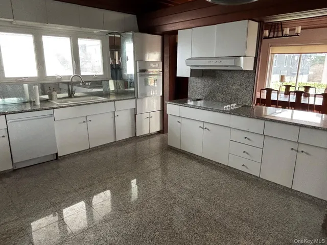 a kitchen with sink and cabinets