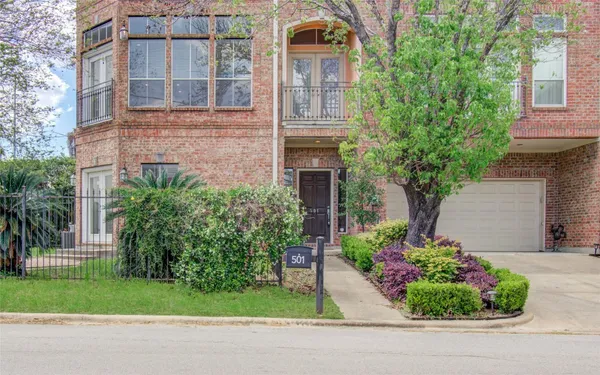 a front view of a house with a yard and a garden