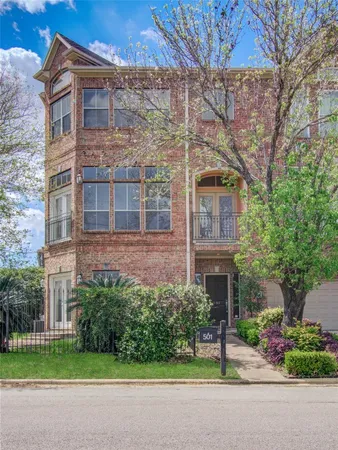 a view of a brick building next to a yard