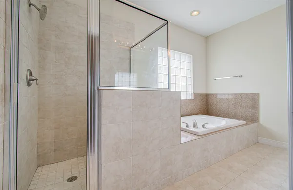 a bathroom with a bathtub and shower