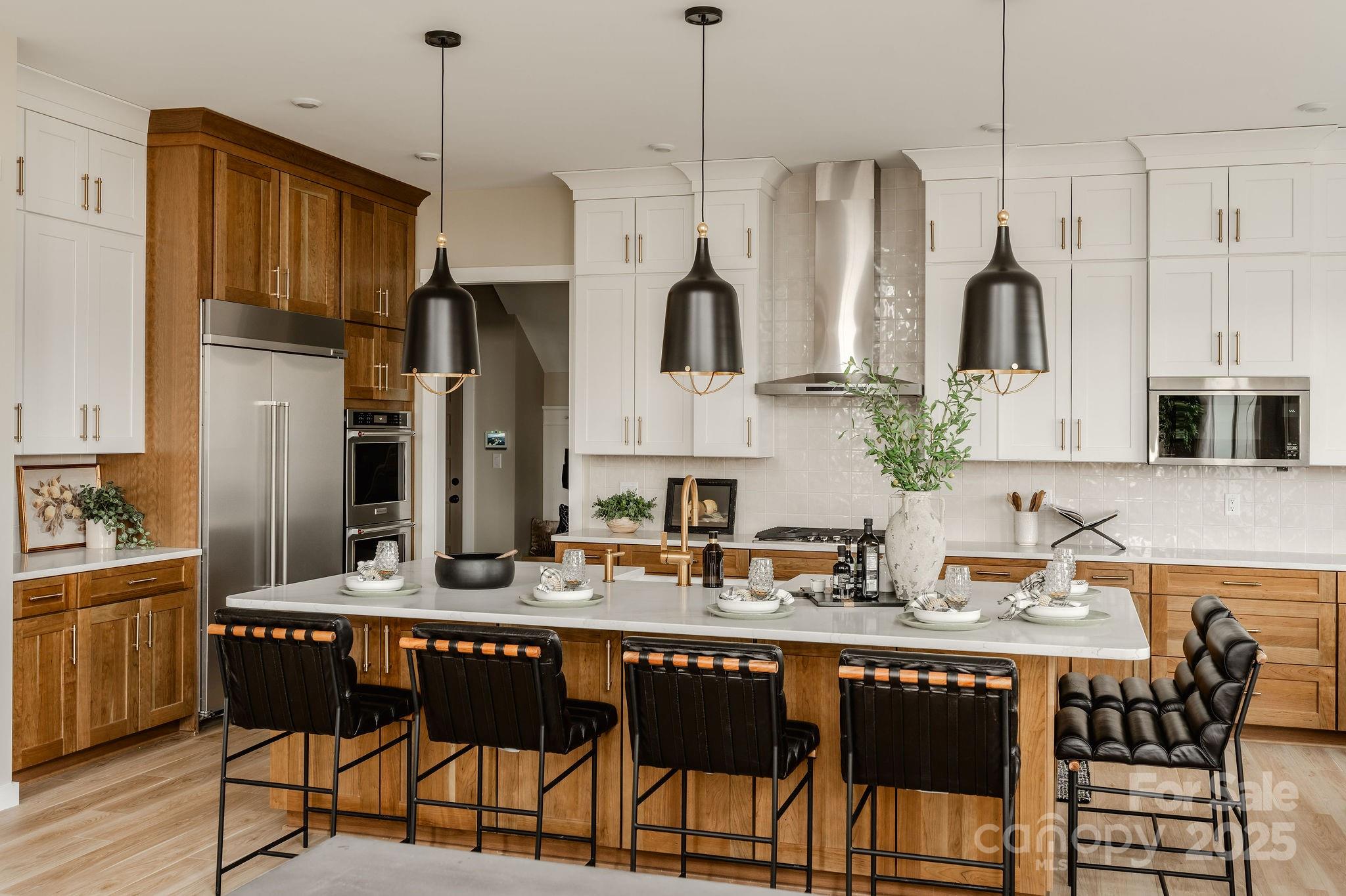 15 Huntersville-Concord Road, Unit DEVONSHIRE Huntersville, NC 28078 - Photo 14 of 48 a kitchen with stainless steel appliances granite countertop a refrigerator a sink dishwasher a dining table and chairs with wooden floor