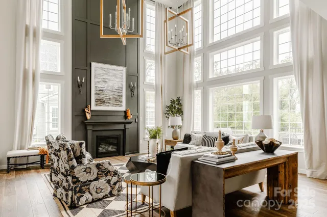 a living room with furniture and large windows