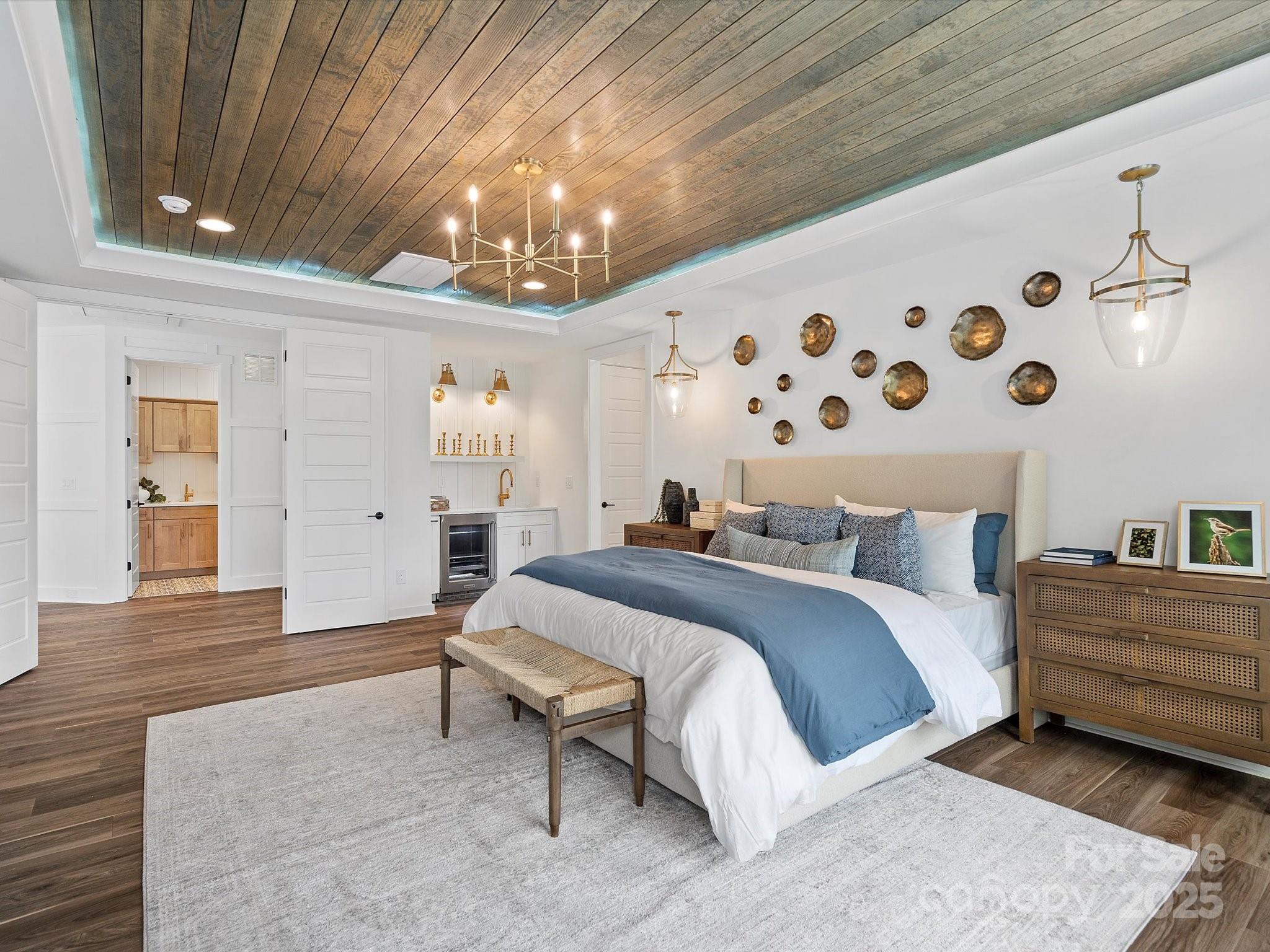 15 Huntersville-Concord Road, Unit DEVONSHIRE Huntersville, NC 28078 - Photo 27 of 48 a spacious bedroom with a bed and a chandelier