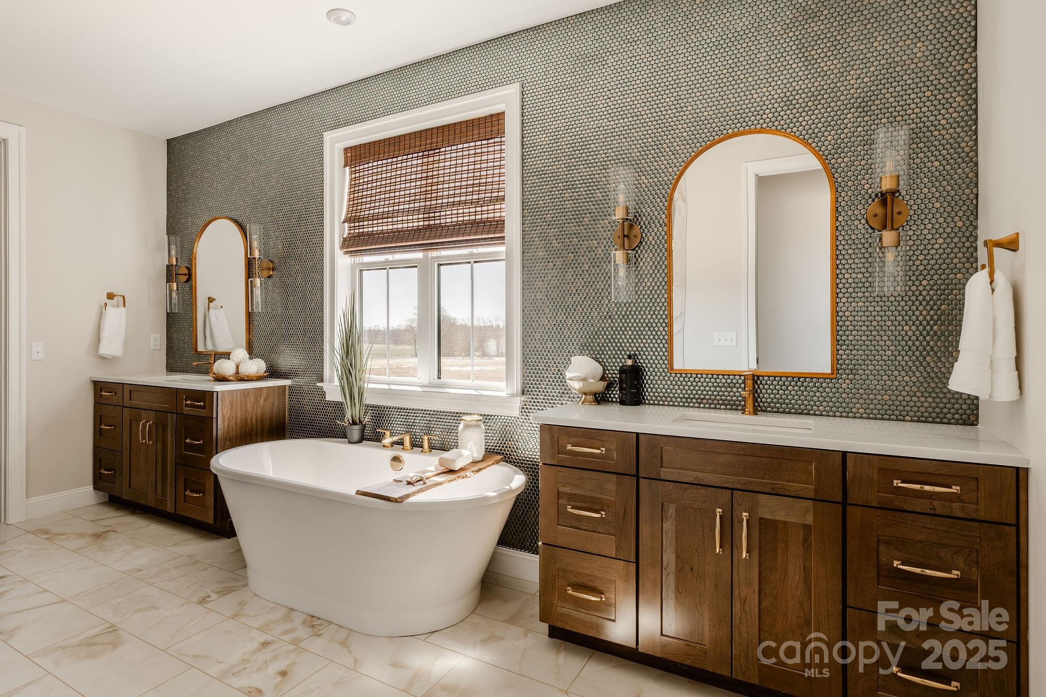 15 Huntersville-Concord Road, Unit DEVONSHIRE Huntersville, NC 28078 - Photo 34 of 48 a bathroom with a double vanity sink a mirror and a bathtub