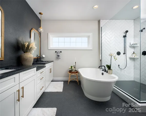 a bathroom with a bathtub sink and mirror