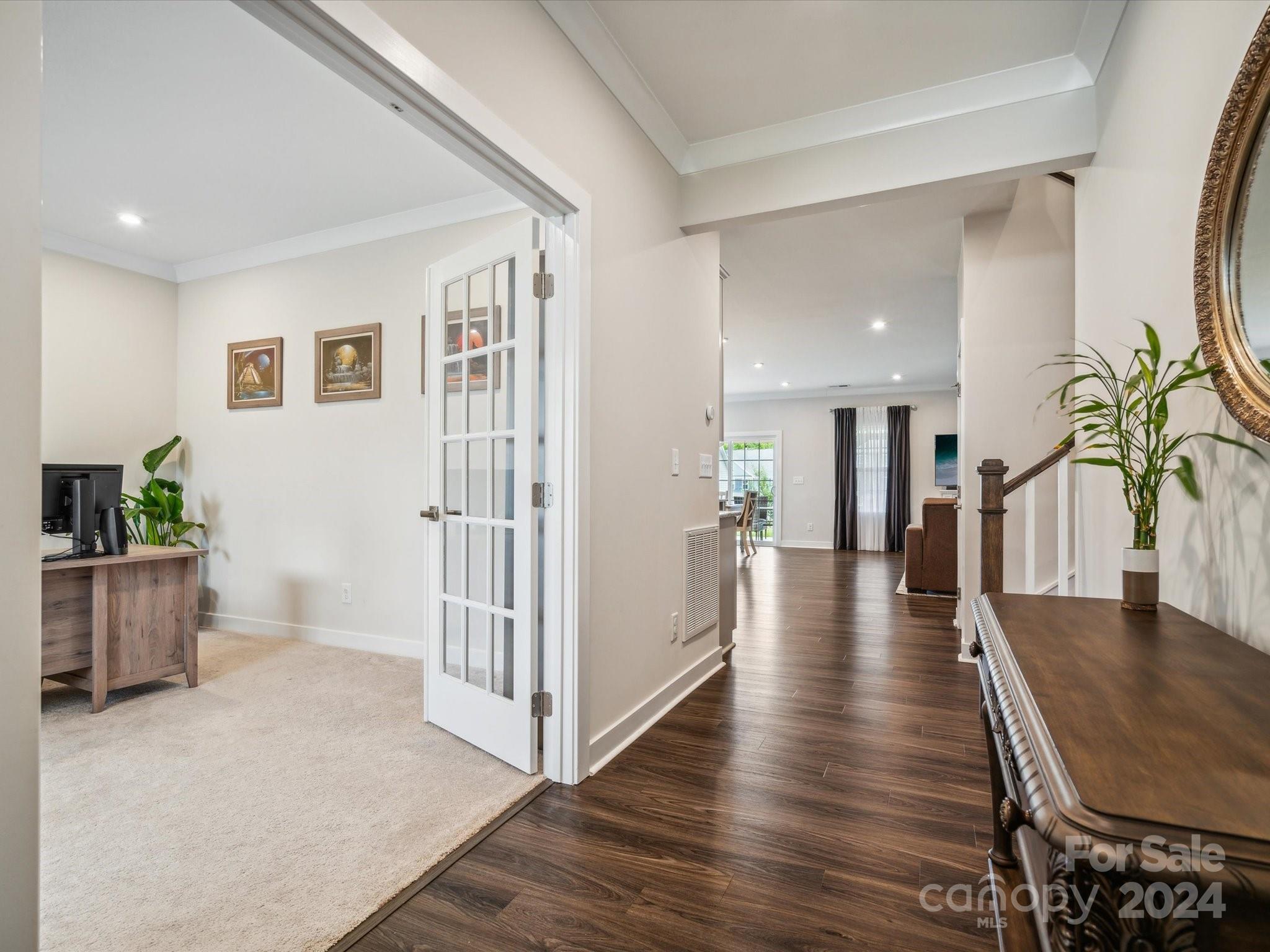7114 Messina Road Indian Land, SC 29707 - Photo 5 of 40 a view of a hallway with wooden floor and a potted plant