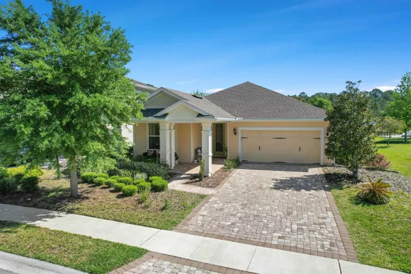 a view of a house with a yard and tree s