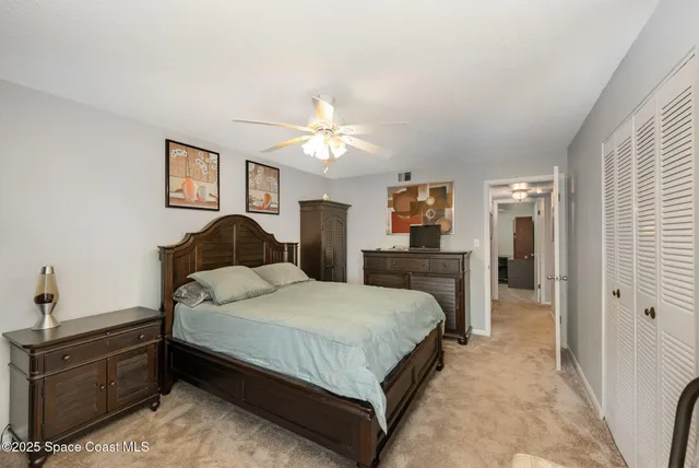 a bedroom with a large bed and a couch