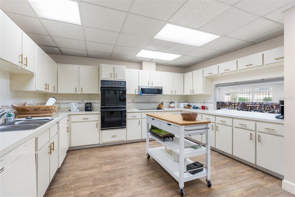 10510 Northwest 28th Place Gainesville, FL 32606 - Photo 37 of 40 a kitchen with stainless steel appliances granite countertop a stove oven and a refrigerator