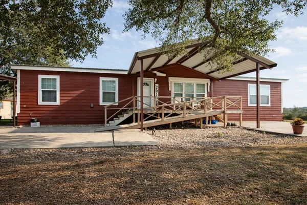 a view of a house with backyard porch and sitting area