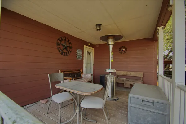 a balcony with table and chairs