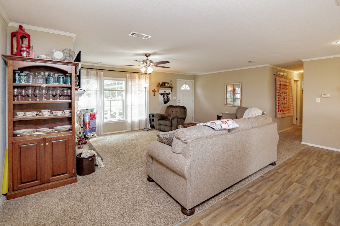 1891 Dworaczyk Road Yorktown, TX 78164 - Photo 19 of 48 a living room with furniture a fireplace and gym equipment